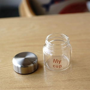 Detailed close-up of a high borosilicate glass mini jar with a secure silver screw-on lid