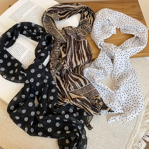 Detailed view of polka dot chiffon scarf necklace with lightweight fabric texture
