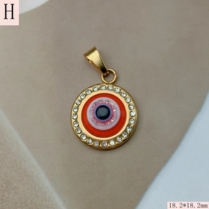 Macro view of 18.2mm gold evil eye heart pendant with colorful enamel and pavé crystals