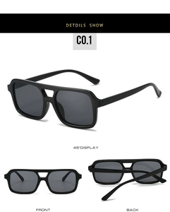 Detail view of square double-bridge sunglasses with black frame and grey lenses