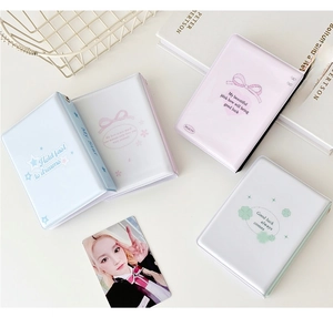 Detailed flat lay of mini PVC photo albums in blue, pink and white with English text