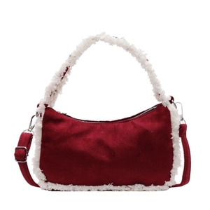 Red suede shoulder bag with white faux fur trim and silver hardware on white background