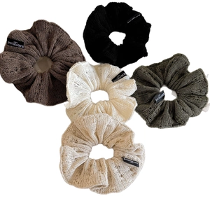 Set of 5 large knit scrunchies in earth tones with stylish decorative labels