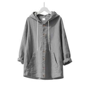 Detail of gray linen hooded shirt showing fabric texture, drawstring, and button closure