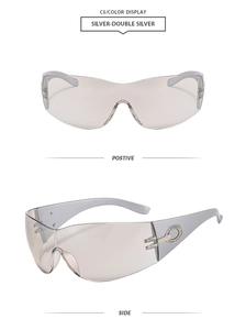 Detail view of silver Y2K futuristic sunglasses with grey lenses and metal oval hinge