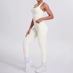 Detail view of cream white ribbed racerback yoga set with side pockets on female model