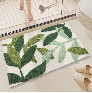 Detail of green leaf pattern bath mat with non-slip texture in a modern bathroom setting