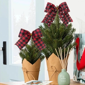 Christmas bow decorations with red black plaid and snowflake patterns on a tree