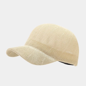 Detail of breathable straw-woven texture and curved brim of the beige baseball cap