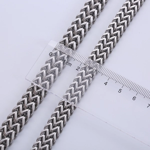 Silver stainless steel Franco chain bracelet showing 6-8mm width measurement with a ruler