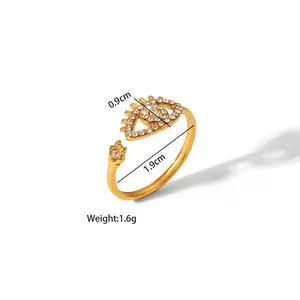 Detailed view of adjustable evil eye ring with white crystals and gold plating