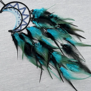 Handmade moon-shaped dream catcher with turquoise feathers and black woven beads