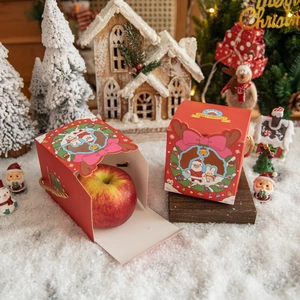Red Christmas Santa hollow gift box with golden handle and fresh apple inside