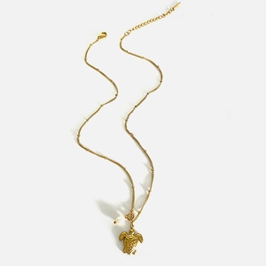 Golden stainless steel necklace featuring a sea turtle pendant with minimalist marine design
