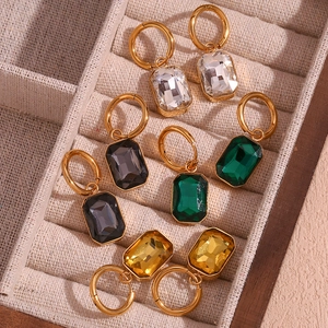 Detail view of four-color rectangular gemstone drop earrings in a luxury jewelry box