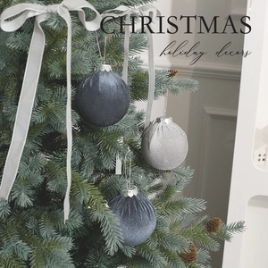 Blue and silver velvet 8cm Christmas balls hanging on tree branch with holiday ribbon