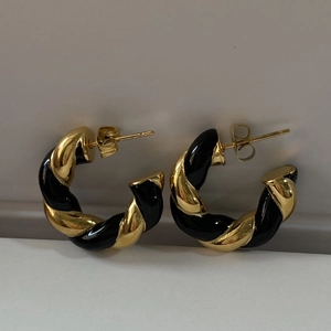 Twisted gold-plated stainless steel hoop earrings with black enamel spiral texture