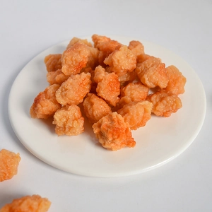 Realistic PVC popcorn chicken food model displayed on a white ceramic plate for props