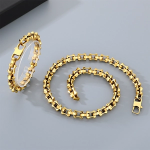 Close-up of golden 10mm curved bamboo link chain necklace and bracelet with lobster clasp