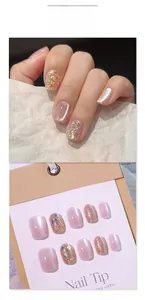 Macro detail of nude pink cat-eye press-on nails with sparkling sequins and glitter