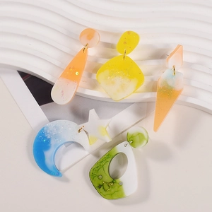 Set of resin drop earrings in geometric moon and star shapes with gold metal studs