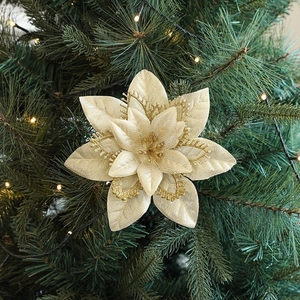 Three-layer champagne gold artificial Christmas flower on tree with warm lights decoration