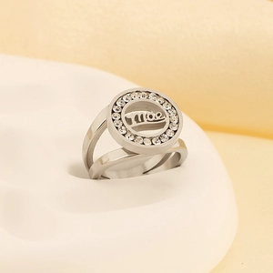 Macro detail of silver steel ring featuring pave-set zircons and hollow Moe lettering