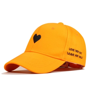 Detail of orange cotton baseball cap featuring black heart and Love Her But Leave Her Wild embroidery