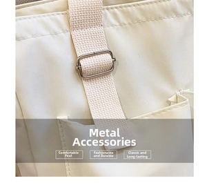 Detailed close-up of a silver metal adjustment buckle on a beige canvas shoulder strap