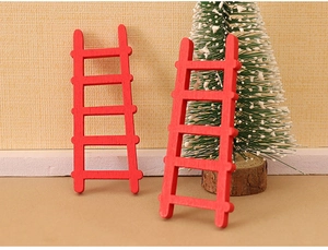 Macro view of two miniature red wooden ladders for dollhouse Christmas DIY scenery decor