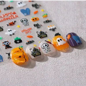 Detailed macro view of 3D Halloween nail stickers with pumpkins and ghost patterns