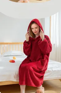Detail of red thick hooded flannel bathrobe with large pocket in a cozy bedroom setting