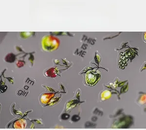 Detailed macro view of 5D embossed fruit nail stickers featuring cherry and apple patterns