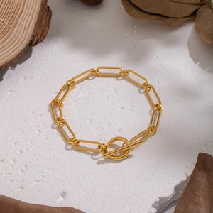 Minimalist gold stainless steel paperclip chain bracelet with OT toggle clasp on stone