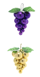 Detail of purple and gold artificial grape cluster ornaments with glossy metallic finish