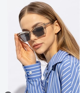 Close-up of modern square sunglasses featuring clear acetate frames and tinted lenses