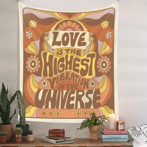 Retro 70s style tapestry with Love Is The Highest Vibration text in warm orange tones