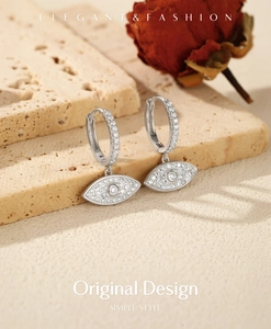 Detailed close-up of S925 sterling silver evil eye hoop earrings with sparkling cubic zirconia