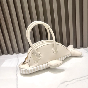 Detail of creative whale-shaped handbag in off-white leather with striped bottom