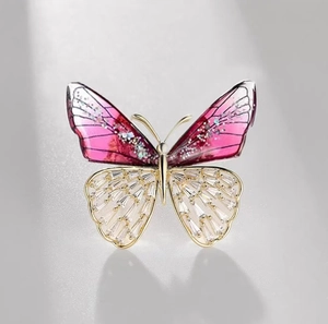 Exquisite crystal butterfly brooch detailed shot, elegant gold tone lapel pin for women.