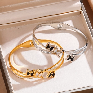 Polished stainless steel butterfly cuff bracelet with zircon pavé in gold and silver