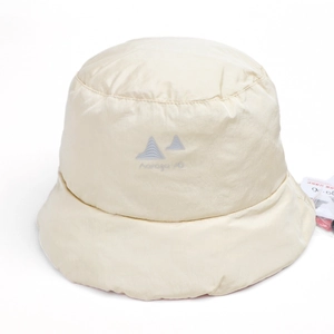 Detail of cream down-filled bucket hat showing water-resistant nylon texture and logo