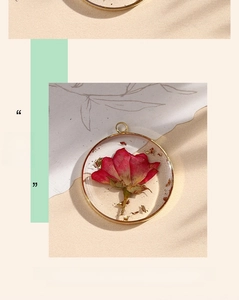 Macro view of red dried rose inside clear resin with a golden copper ring frame