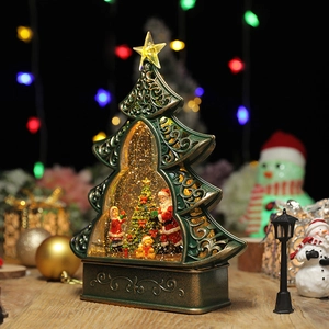 Green Christmas tree water lantern music box with Santa figurines and warm LED lights
