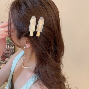 Detail of ice cream hair clips with yellow translucent texture and colorful crystals