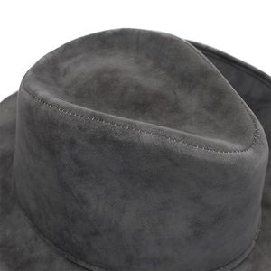 Macro shot of dark grey matte felt texture and fine stitching on the wide brim hat