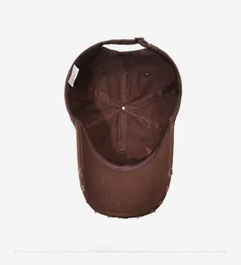 Detailed inner view of brown washed cotton baseball cap with labels and distressed brim