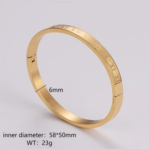 Macro detail of 6mm gold stainless steel bangle showing Roman numeral engravings