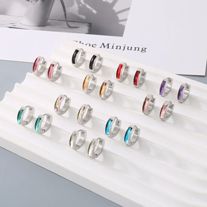 Close-up of titanium steel huggie earrings featuring ten colors of rectangular zircons