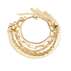 Close-up of gold bohemian chain set with snake, twist, paperclip and box link textures